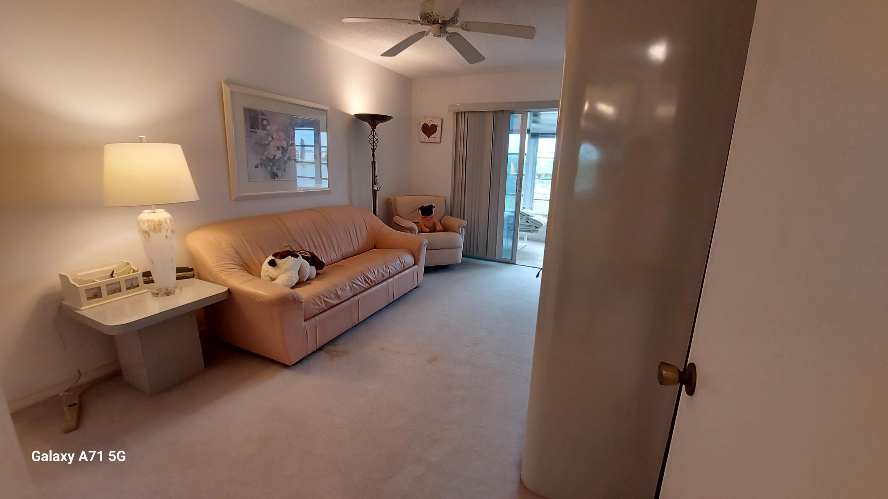 4079 Cornwall East, Unit 4079 Boca Raton, FL 33434 - Photo 11 of 41 a living room with furniture and a lamp