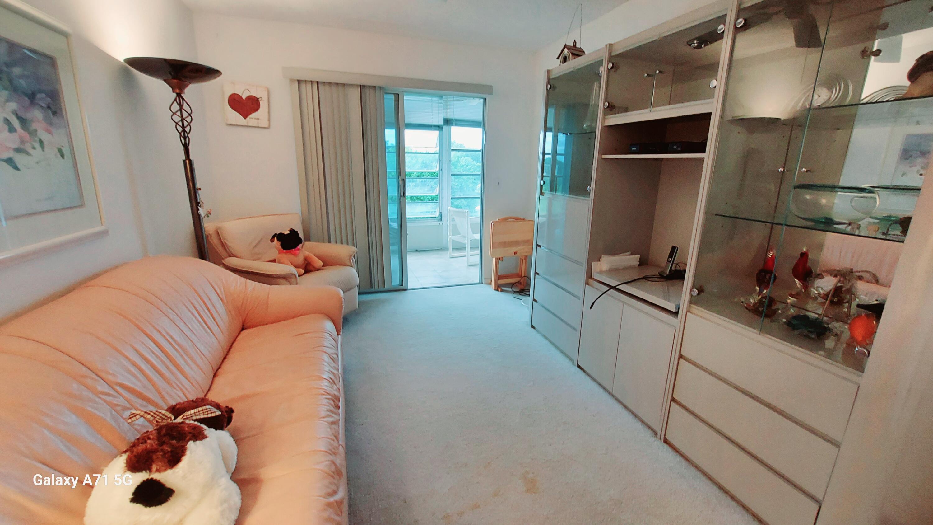 4079 Cornwall East, Unit 4079 Boca Raton, FL 33434 - Photo 12 of 41 a bedroom with a bed and a refrigerator