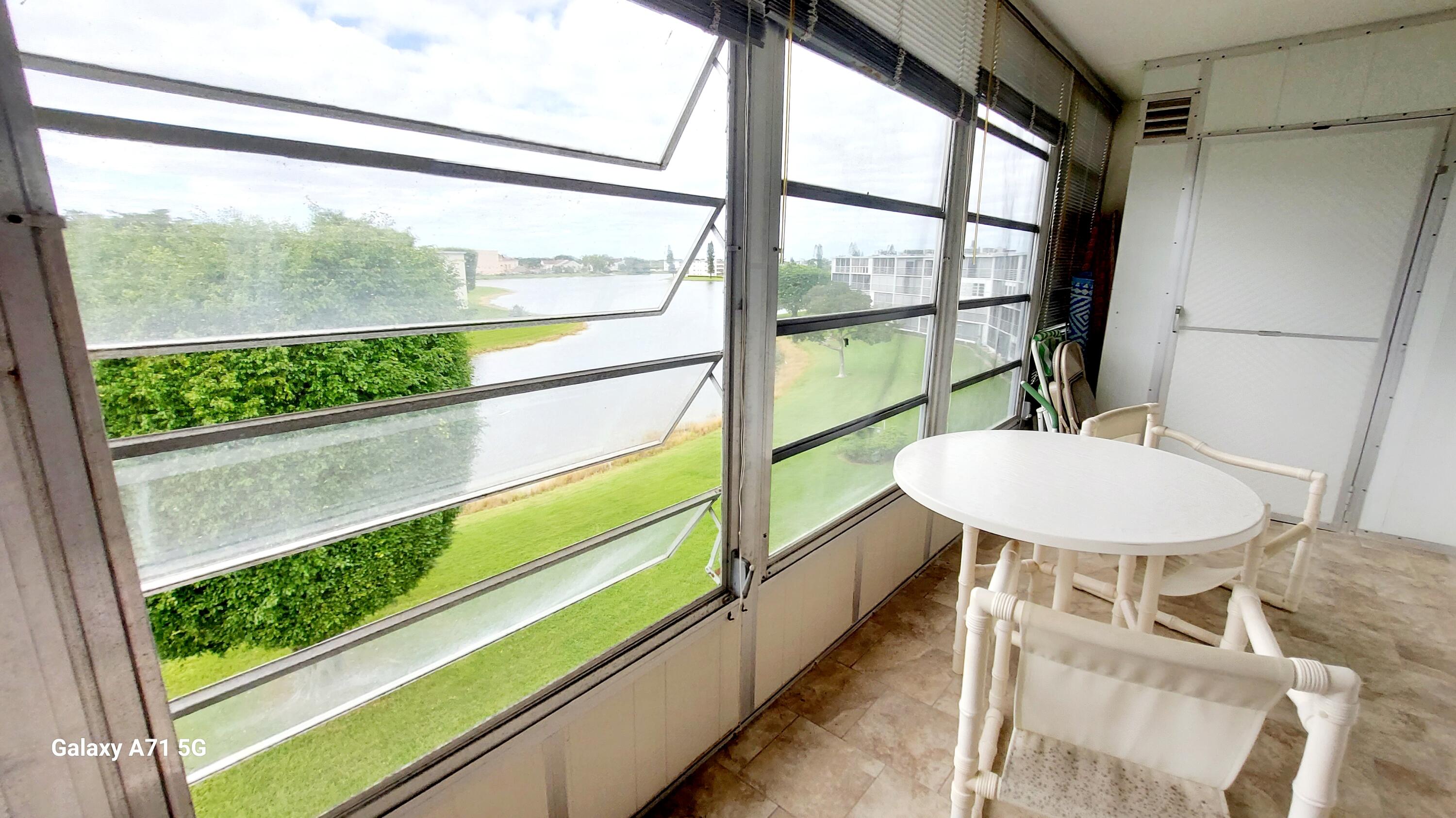 4079 Cornwall East, Unit 4079 Boca Raton, FL 33434 - Photo 16 of 41 a view of a porch with furniture and a yard