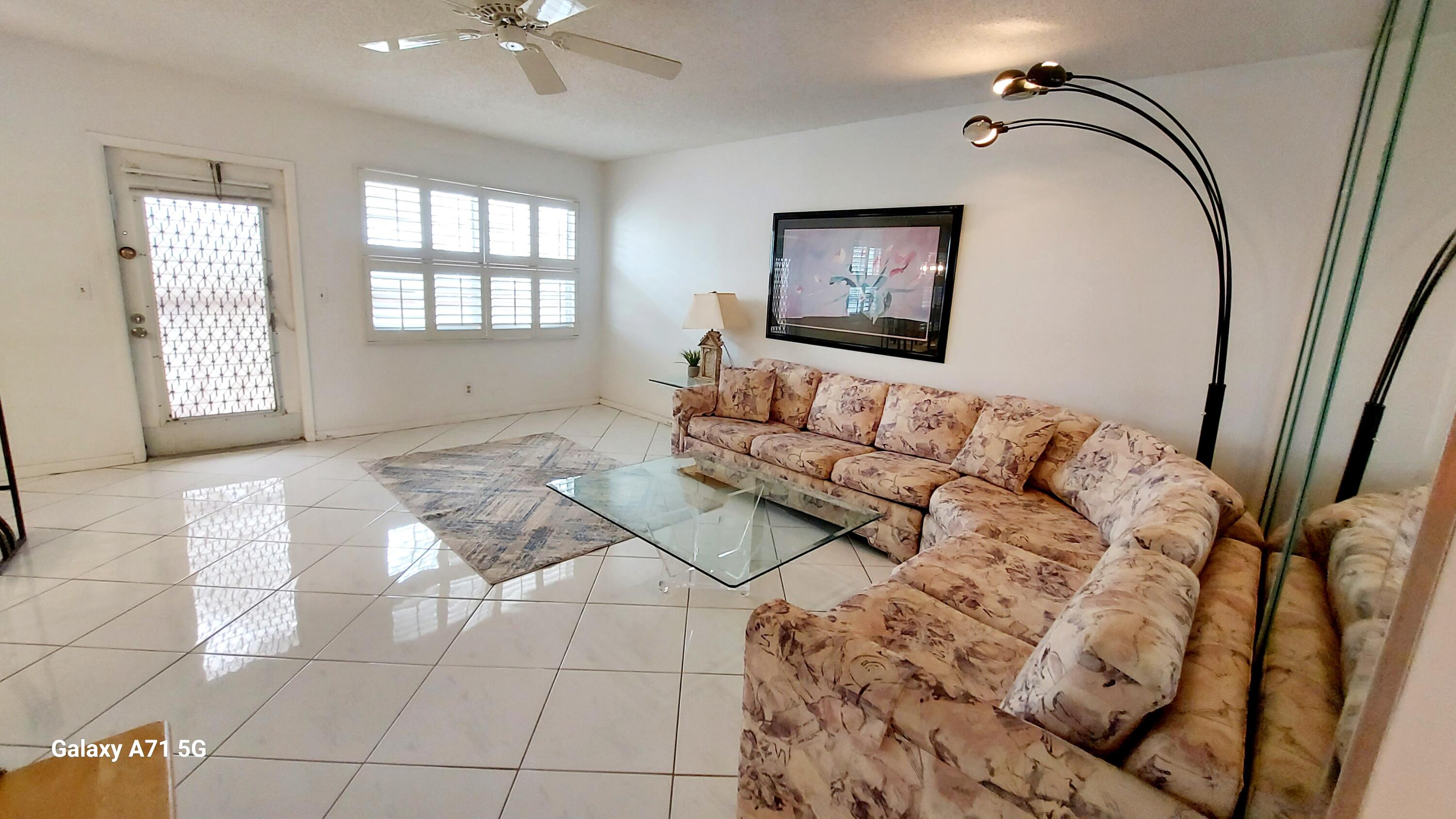 4079 Cornwall East, Unit 4079 Boca Raton, FL 33434 - Photo 2 of 41 a living room with furniture and a window