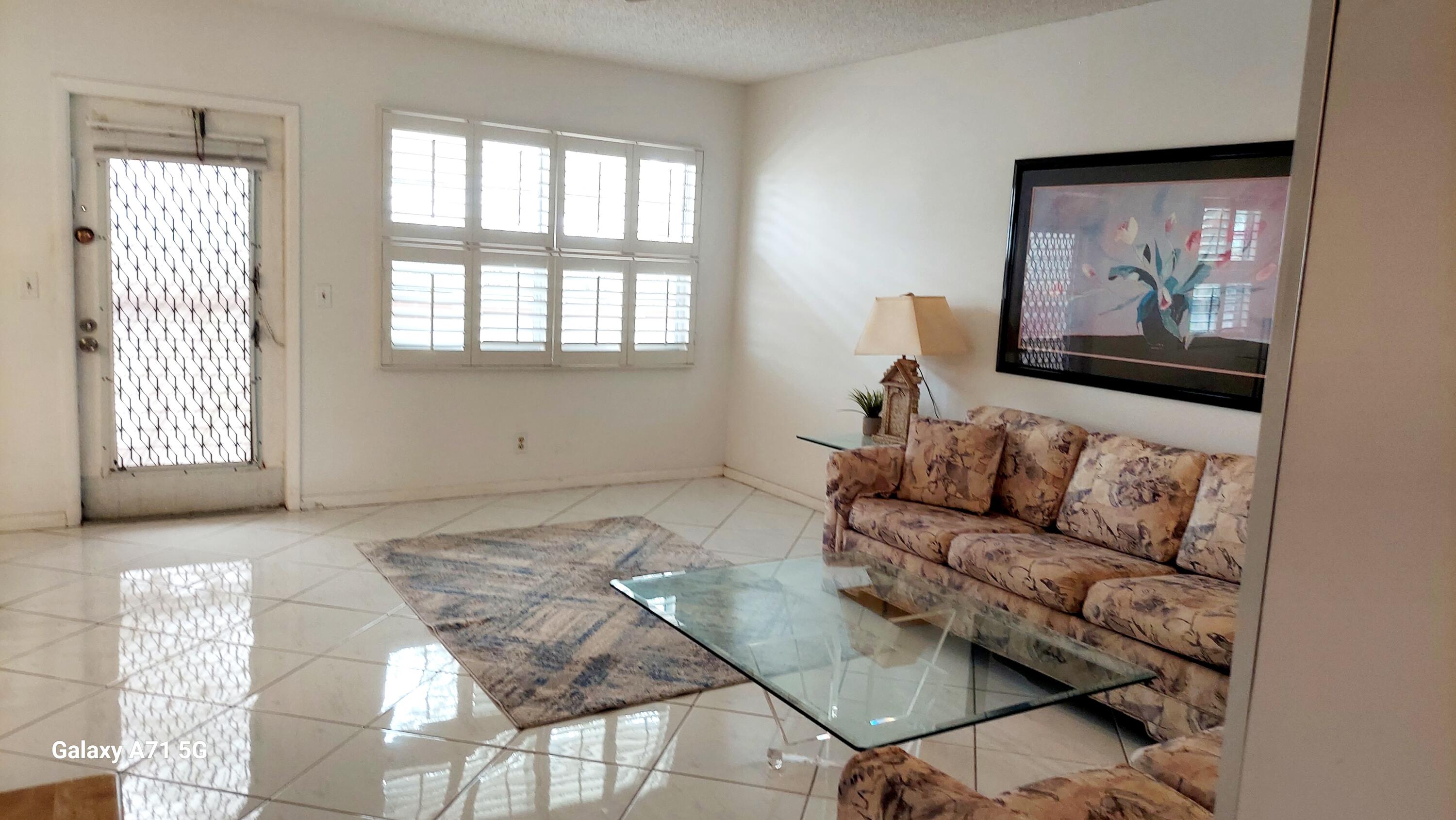 4079 Cornwall East, Unit 4079 Boca Raton, FL 33434 - Photo 4 of 41 a living room with furniture and a window