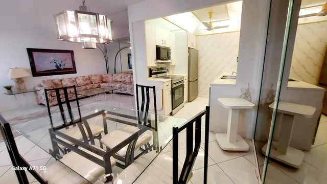 a view of a livingroom with furniture a flat screen tv and outdoor view