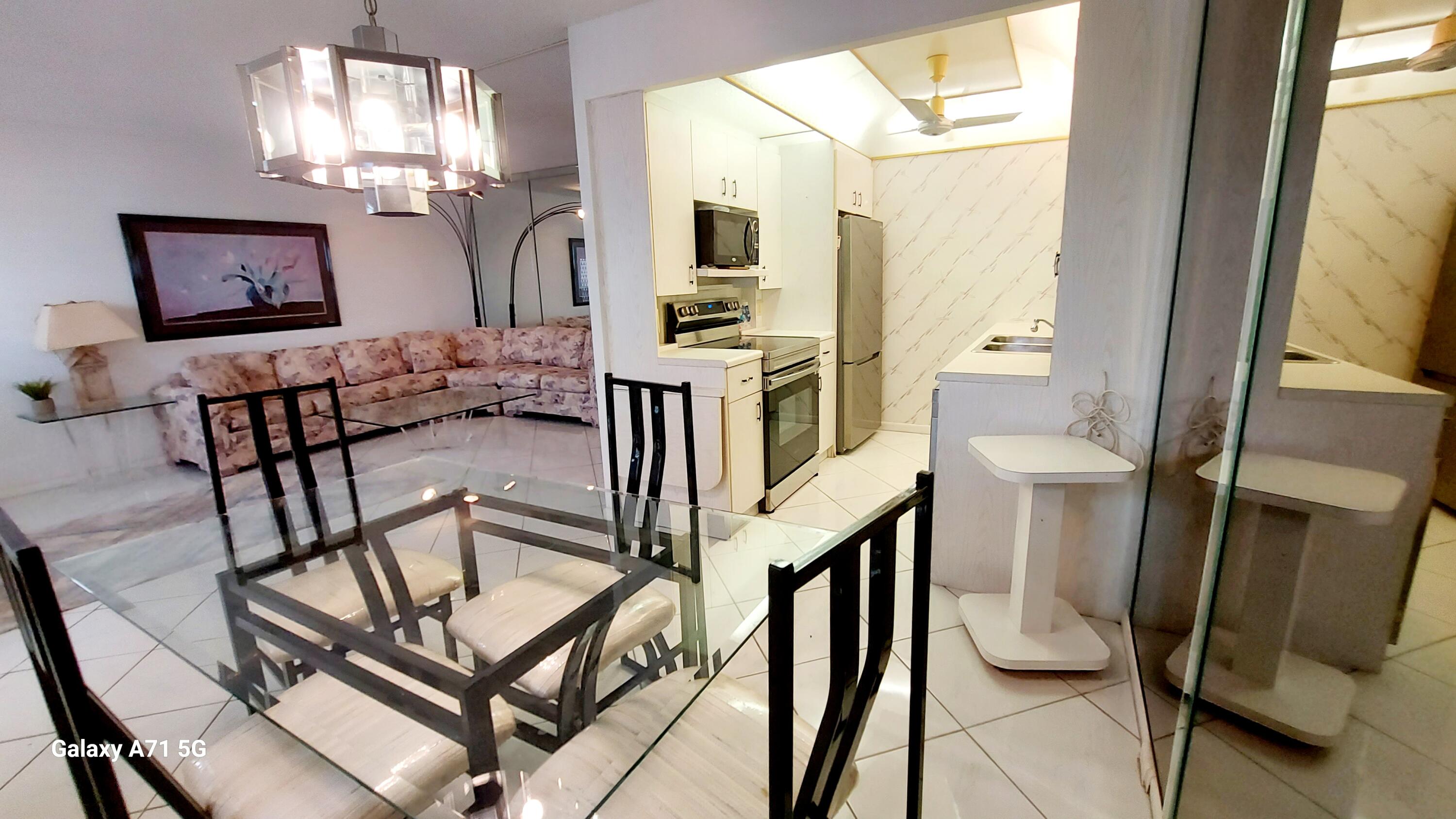 4079 Cornwall East, Unit 4079 Boca Raton, FL 33434 - Photo 5 of 41 a view of a livingroom with furniture a flat screen tv and outdoor view