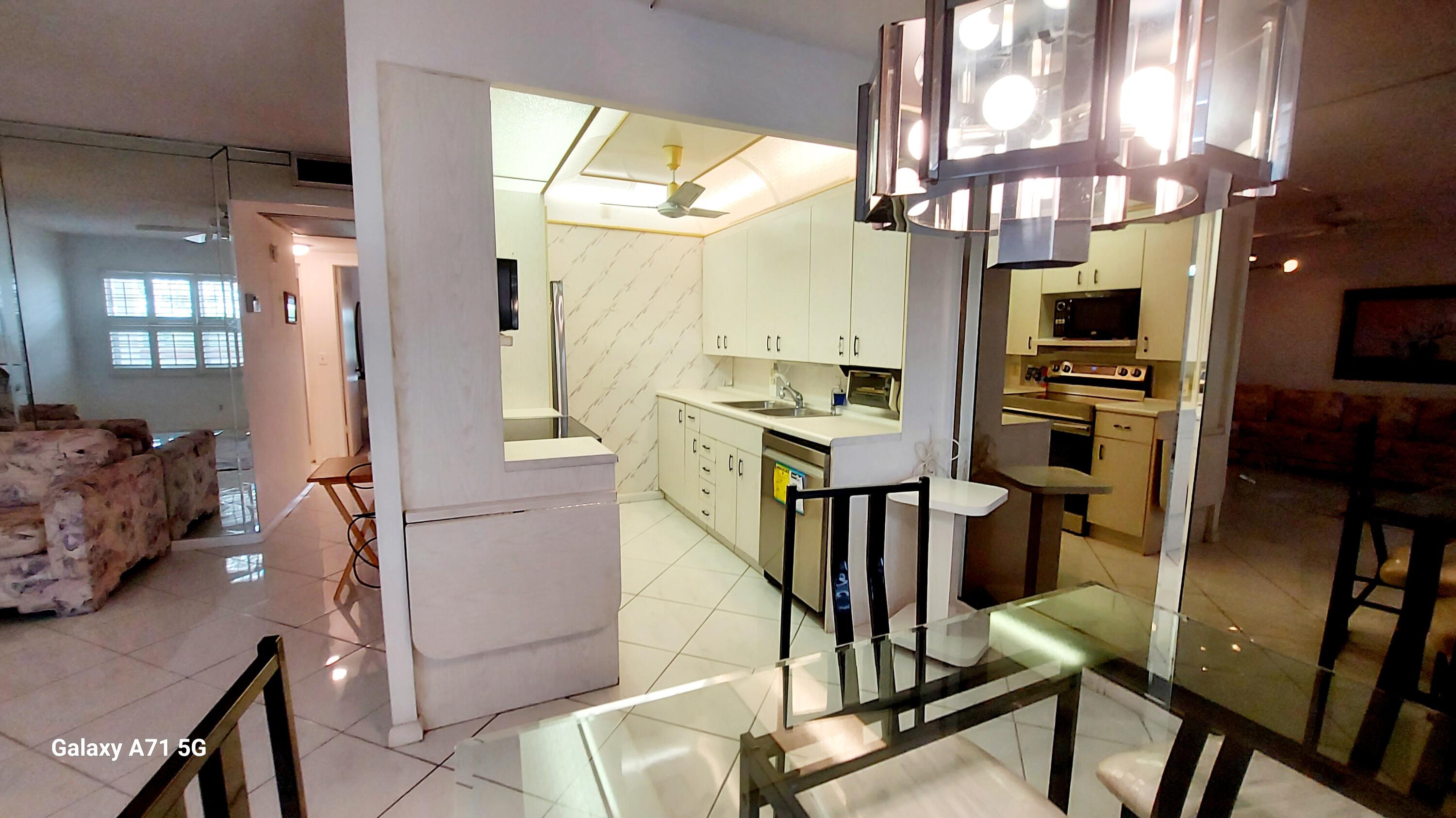 4079 Cornwall East, Unit 4079 Boca Raton, FL 33434 - Photo 6 of 41 a view of a kitchen with furniture and a window