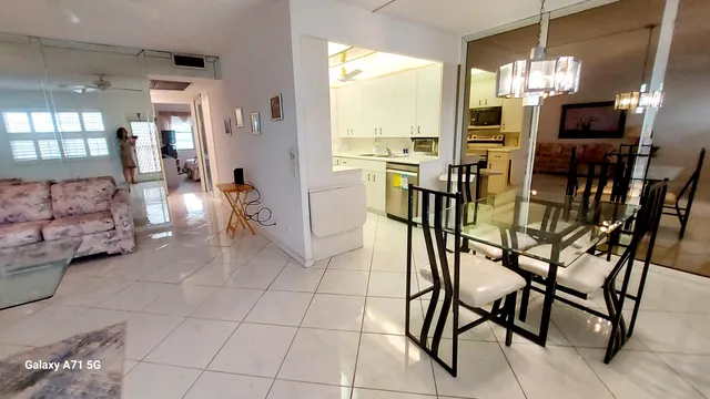 a view of a dining room with furniture and chandelier