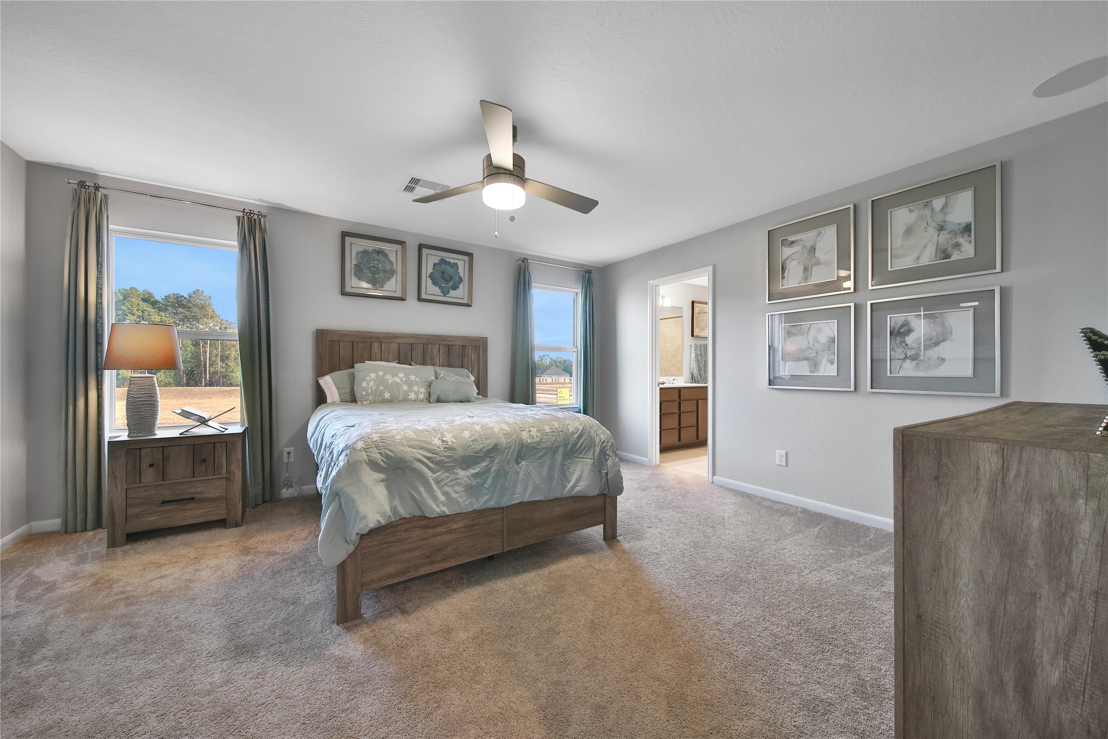 3306 Forest Chitto Dr Spring Spring, TX 77373 - Photo 17 of 35 a spacious bedroom with a large bed and a chandelier