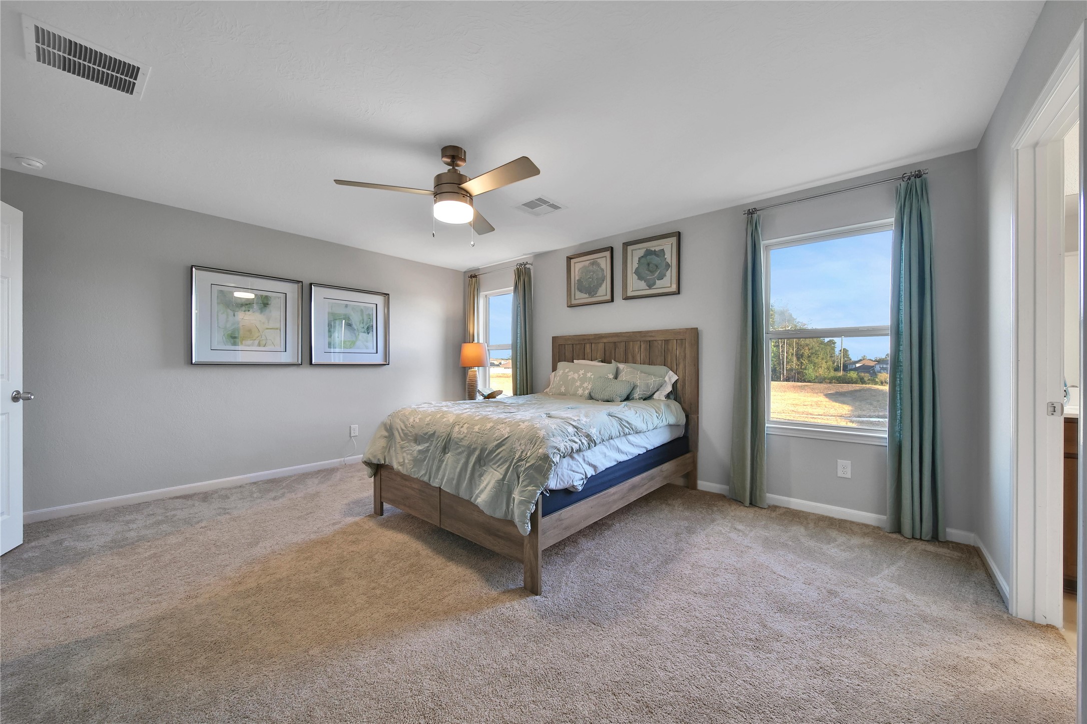 3306 Forest Chitto Dr Spring Spring, TX 77373 - Photo 19 of 35 a bedroom with a large bed and a chandelier