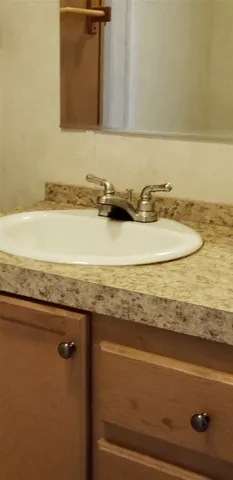 a bathroom with a granite countertop