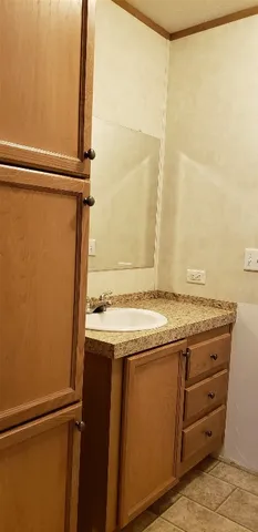 a view of a kitchen with a sink and wooden floor