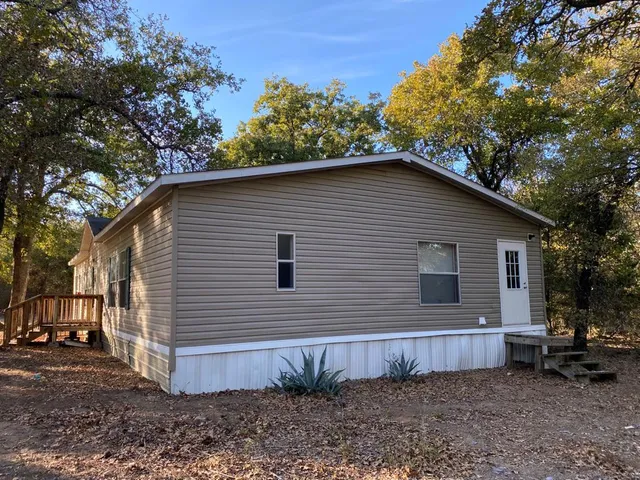 a side view of a house with a yard
