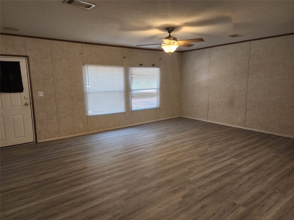 8315 Burleson Manor Road, Unit A Manor, TX 78653 - Photo 4 of 21 an empty room with wooden floor fan and windows