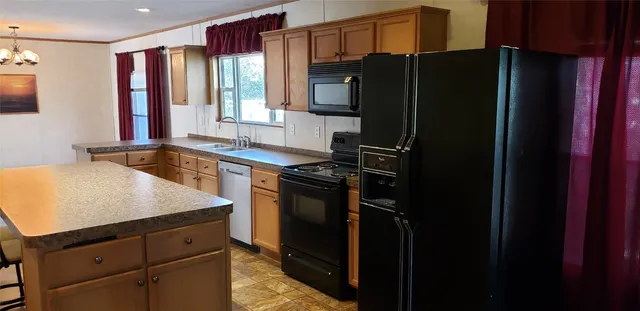 a kitchen with a refrigerator and a sink