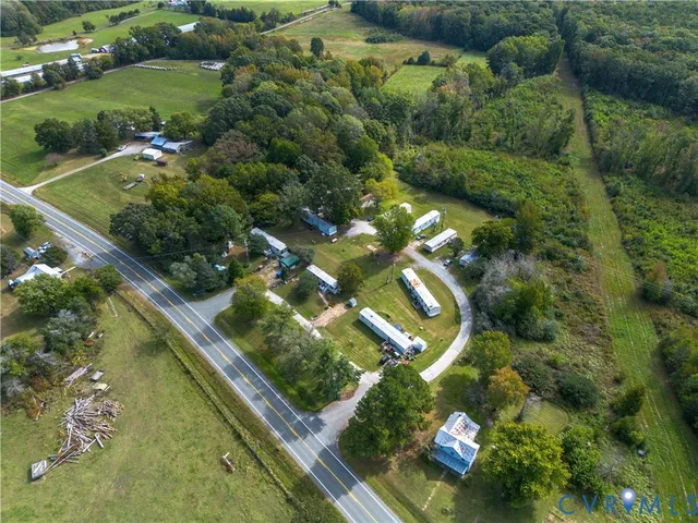 an aerial view of a residential houses with outdoor space and street view