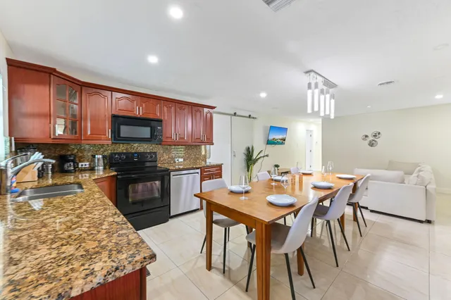 a view of a dining room with furniture and a chandelier
