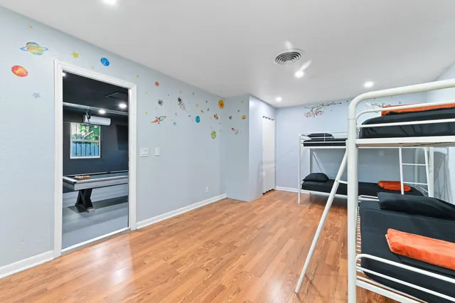 a view of a room with wooden floor and windows
