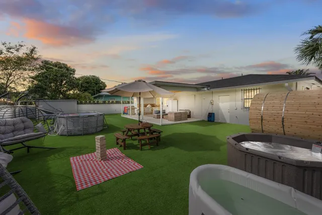 a view of a backyard with table and chairs