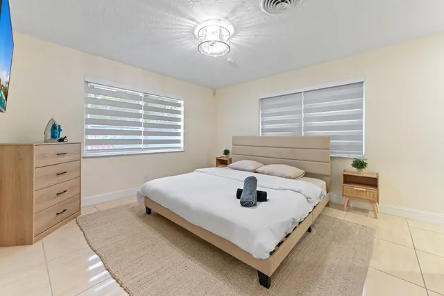 a bedroom with a bed and a flat screen tv