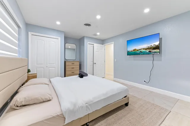 a bedroom with a bed and lamp