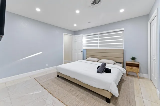 a bedroom with a bed and a table