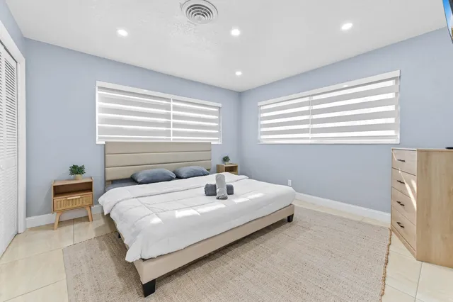 a bedroom with a bed and a flat tv screen