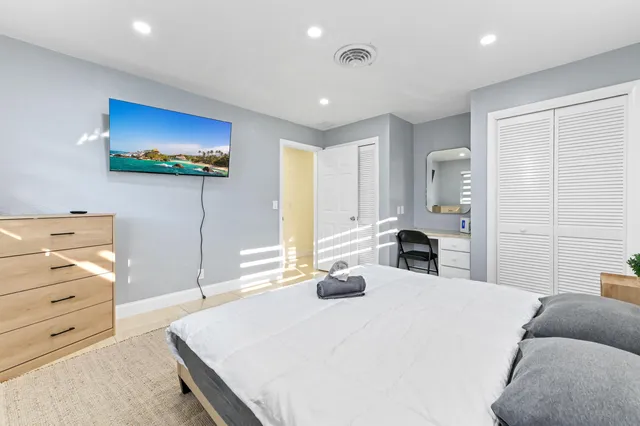 a bedroom with a bed and a chandelier