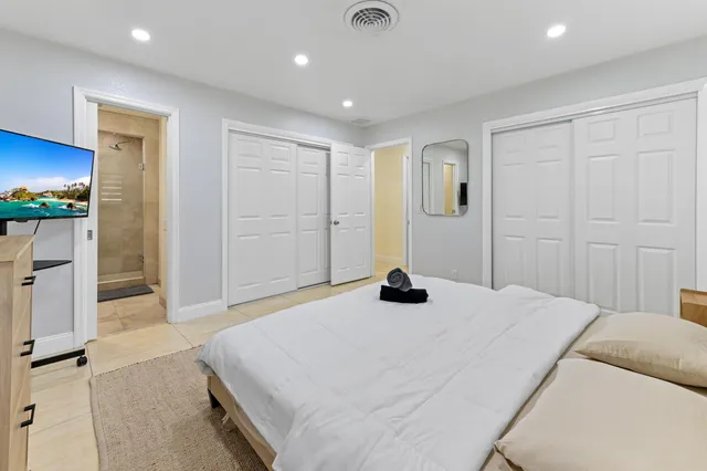 a bathroom with a sink a mirror a bathtub and shower