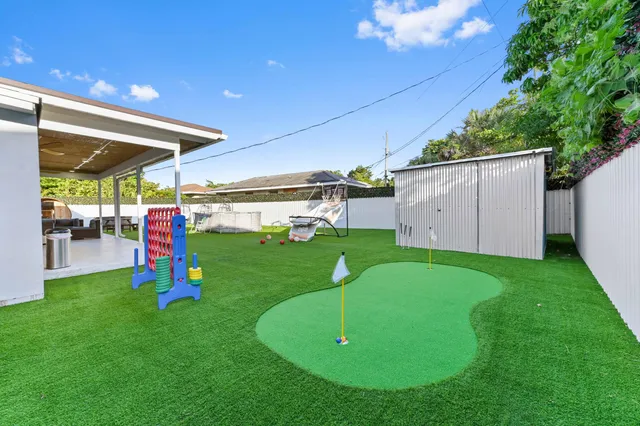 a front view of a house with a yard and potted plants