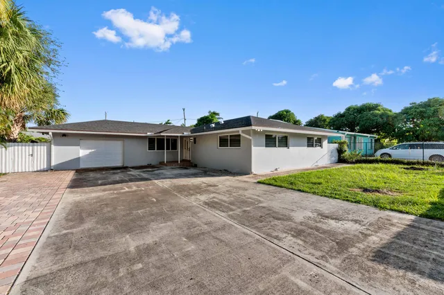 a view of a bedroom with wooden floor and windows