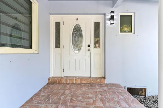 a living room with furniture and a dining table with kitchen view