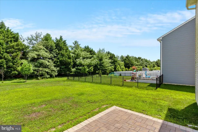 a view of a backyard with a garden and trees