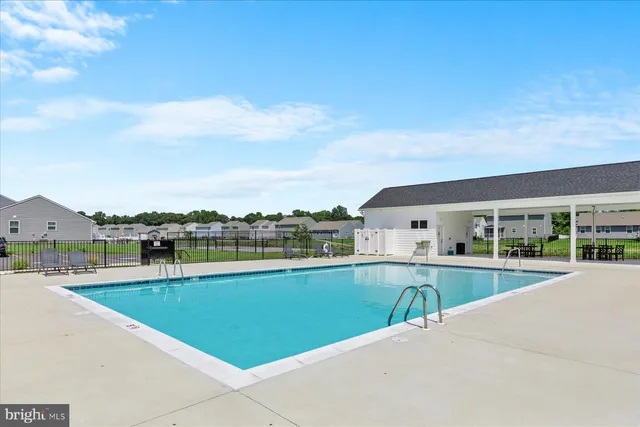 a view of a house with a swimming pool and a balcony