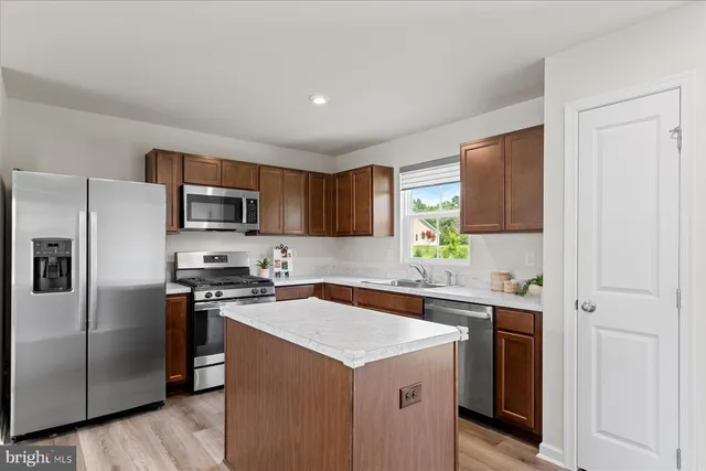 a kitchen with a sink stove and refrigerator