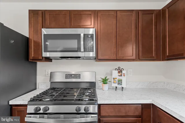 a kitchen with wooden cabinets and a stove top oven