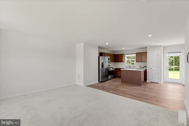 a view of a kitchen with a sink and a refrigerator