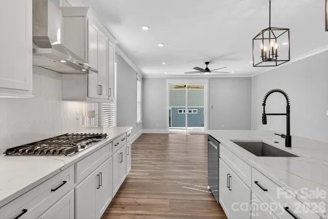a kitchen with sink a stove and cabinets