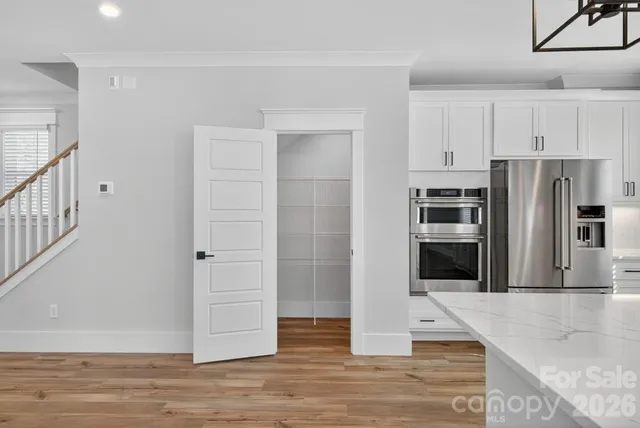 a kitchen with stainless steel appliances granite countertop a refrigerator and a sink