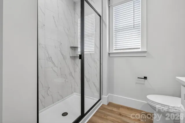 a bathroom with a toilet and a shower