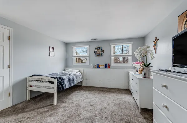 a room with a bed and a flat screen tv