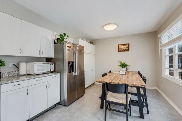 a view of a dining room with furniture and a kitchen