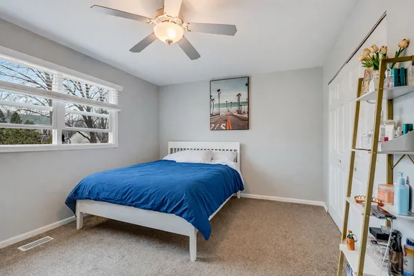 a bedroom with a bed and a window