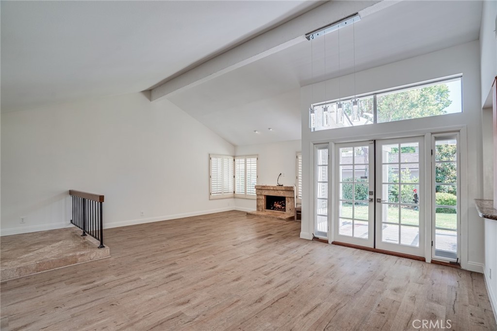 49 East Yale Loop, Unit 26 Irvine, CA 92604 - Photo 6 of 63 a view of an empty room with a window and wooden floor