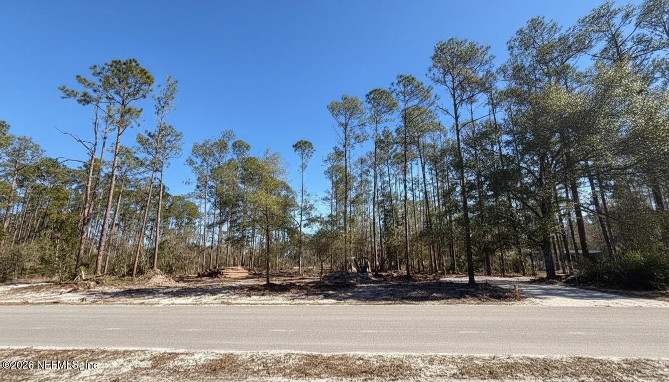 a view of a road with a house in the background