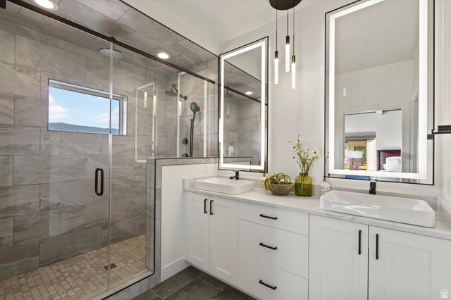 4499 North Seven Bridges Road, Unit 9 Eden, UT 84310 - Photo 19 of 65 Dual vanity with vessel sinks, white cabinetry, and matte black hardware
