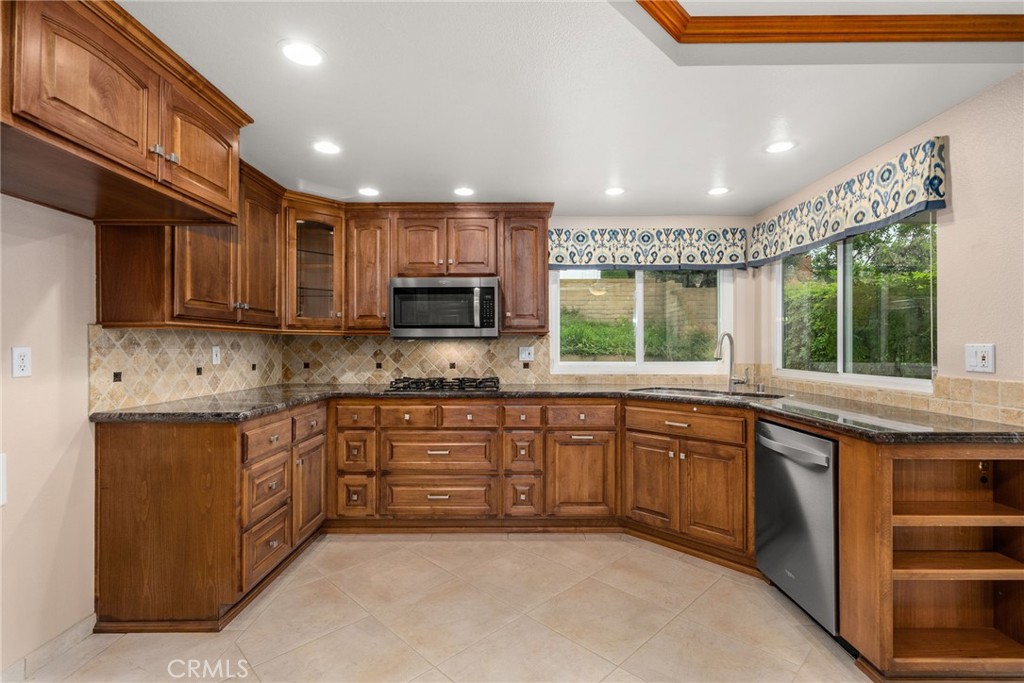 198 Sunflower Street Brea, CA 92821 - Photo 14 of 43 a kitchen with stainless steel appliances granite countertop wooden cabinets a sink and dishwasher a stove top oven