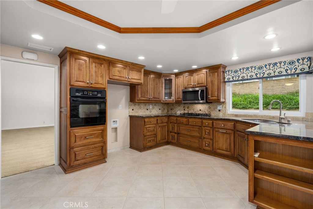 198 Sunflower Street Brea, CA 92821 - Photo 15 of 43 a kitchen with stainless steel appliances kitchen island granite countertop a stove and cabinets