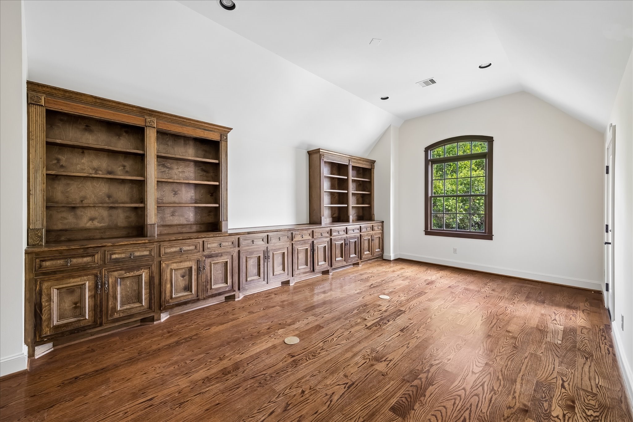 2246 Branard Street Houston, TX 77098 - Photo 33 of 40 Vaulted ceilings and wall-to-wall custom cabinetry create a flexible and functional upper-level bedroom or living space.