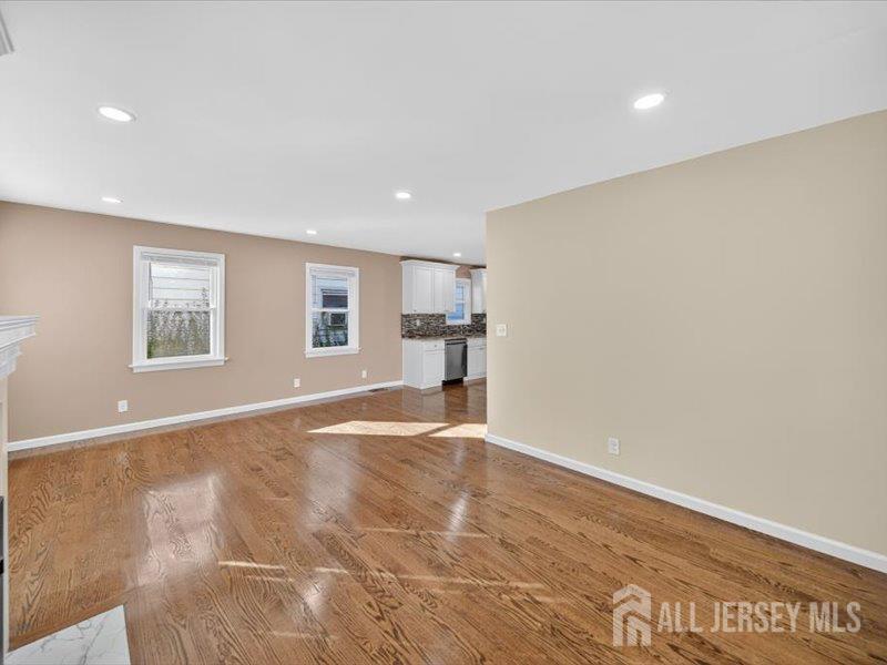 54 Freeman Street Woodbridge, NJ 07095 - Photo 12 of 35 a view of empty room with wooden floor and kitchen