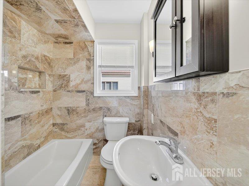 54 Freeman Street Woodbridge, NJ 07095 - Photo 18 of 35 a bathroom with a sink and a bathtub