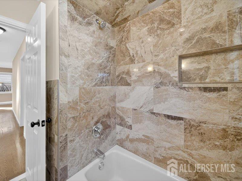 54 Freeman Street Woodbridge, NJ 07095 - Photo 19 of 35 a bathroom with a bathtub