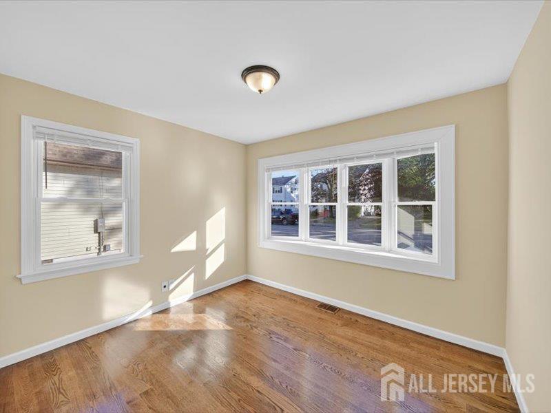 54 Freeman Street Woodbridge, NJ 07095 - Photo 20 of 35 a view of an empty room with a window and wooden floor